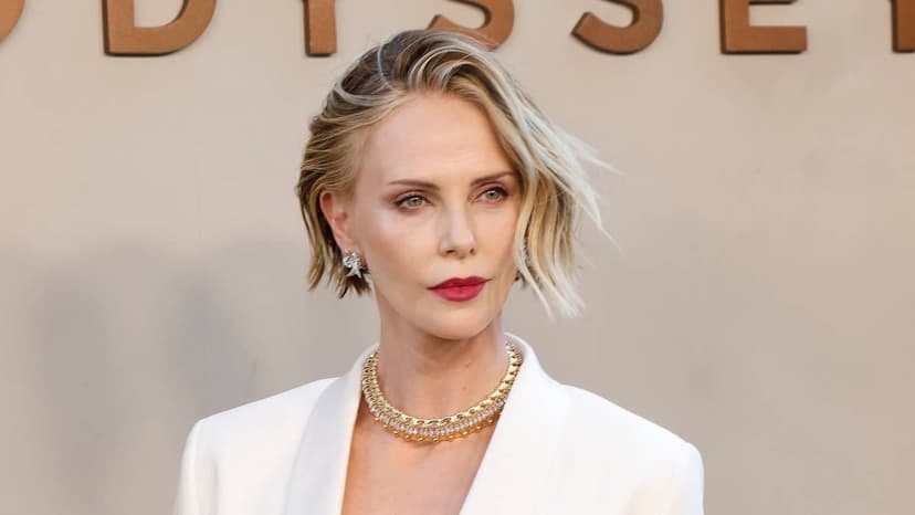 Charlize Theron Shines in White Amidst Body Talk