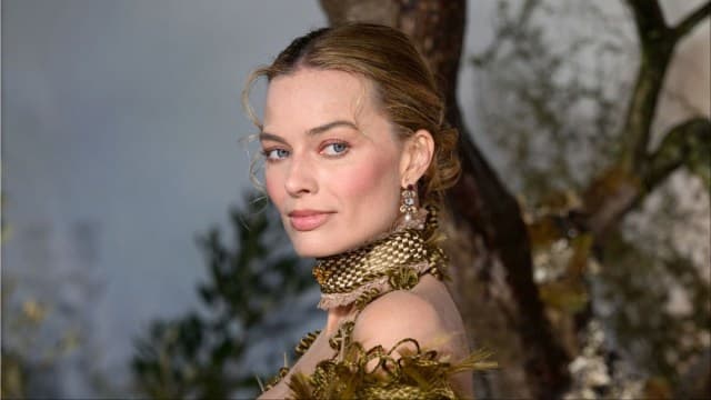 Robbie's Bold Chanel Swimsuit Steals the Show